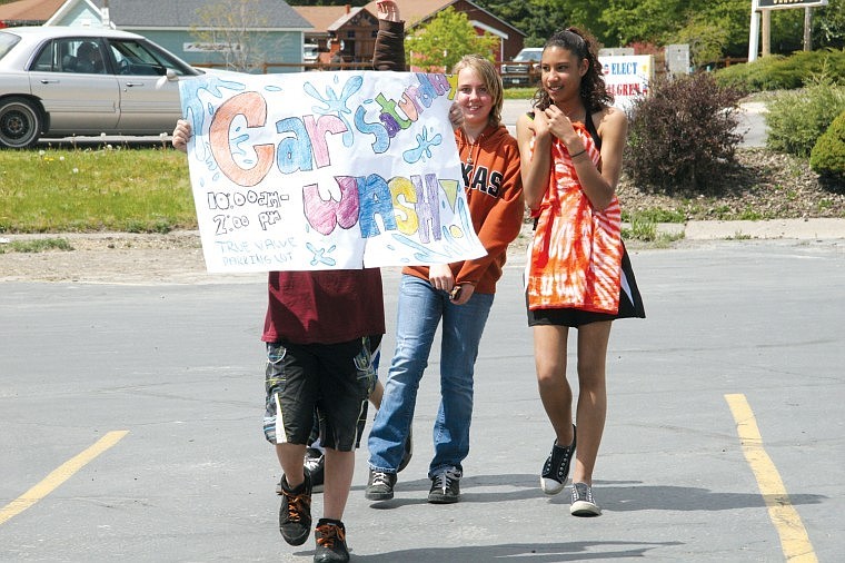 Jazmine Hould and Kenya Anderson take their turn promoting the Honor Pass car wash last Saturday in the Tru Value parking lot.