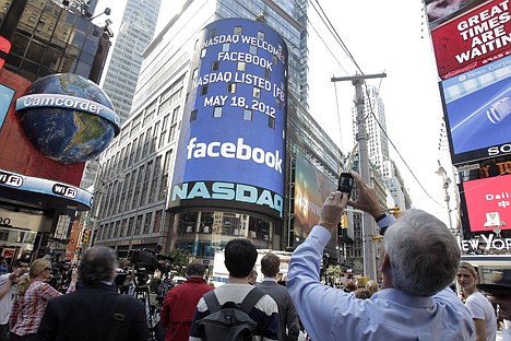 &lt;p&gt;A man stops to photograph Nasdaq in Times Square as Facebook has its IPO on Friday in New York. The social media company priced its IPO on Thursday at $38 per share, and beginning Friday regular investors will have a chance to buy shares.&lt;/p&gt;