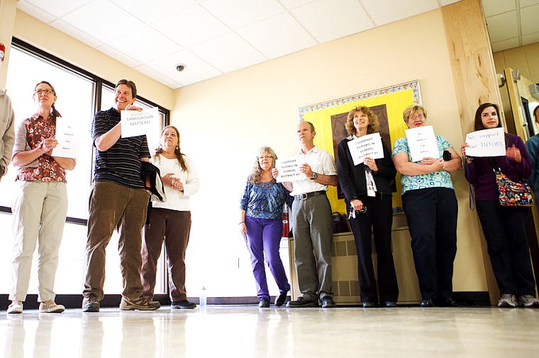 &lt;p&gt;Kalispell Public Schools staff and community members hold up signs Tuesday evening showing their support for tutors as school board members enter Kalispell Middle School for a board meeting.&lt;/p&gt;