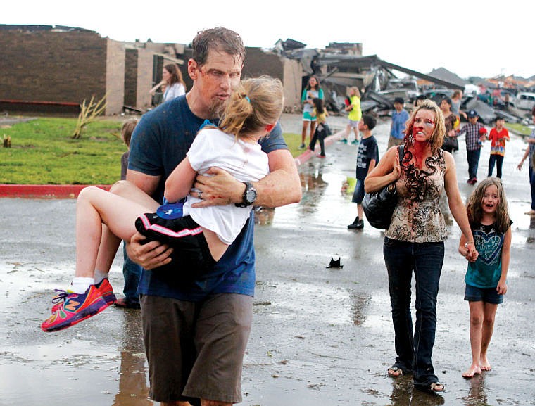 &lt;p&gt;Teachers carry children away from Briarwood Elementary school after a tornado destroyed the school in south Oklahoma City, Monday, May 20, 2013. A monstrous tornado roared through the Oklahoma City suburbs, flattening entire neighborhoods with winds up to 200 mph, setting buildings on fire and landing a direct blow on an elementary school. (AP Photo/The Oklahoman, Paul Hellstern)&lt;/p&gt;