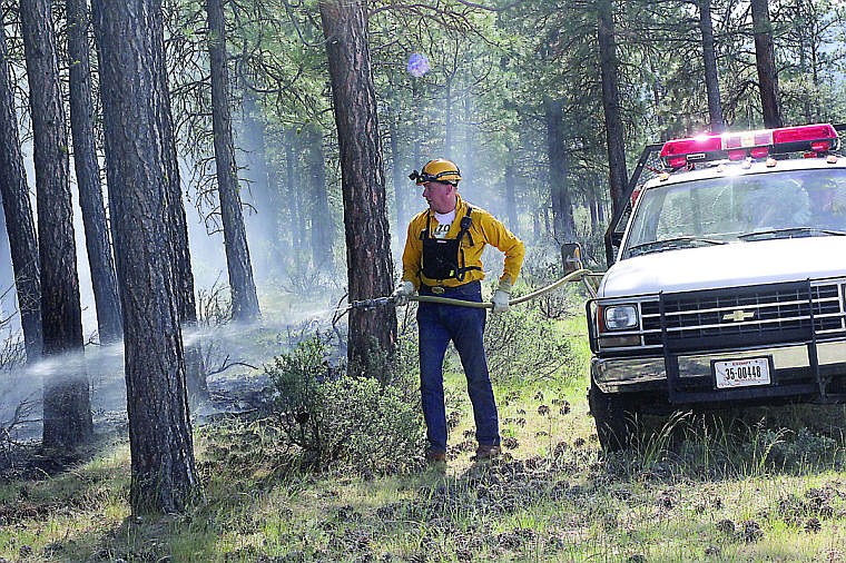 &lt;p&gt;Plains Volunteer Fire Department Chief Joe Sheppard works to extinguish flames on Pilgrim Road.&#160;&lt;/p&gt;