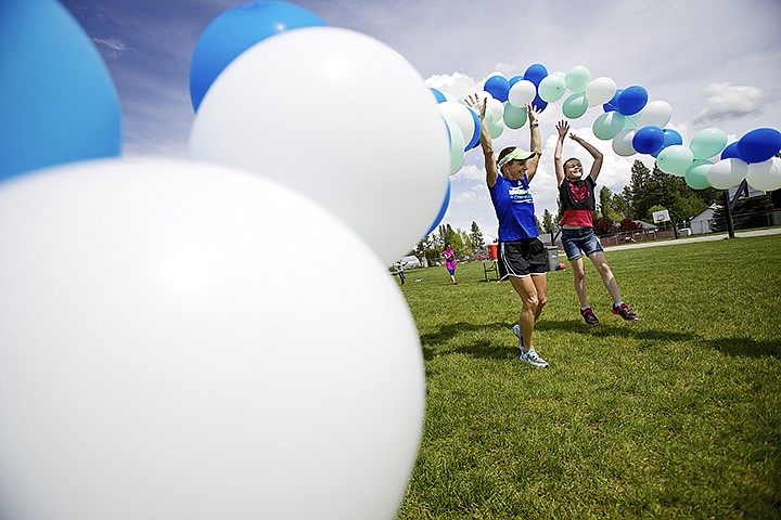 &lt;p&gt;JEROME A. POLLOS/Press Suzanne Endsly, a local Ironman triathlete, and Hailey Thaxton, 8, celebrates as the begin another lap around the field behind Hayden Meadows Elementary during a run-walk for fun fitness challenge lunch-time lap session Friday. More than 500 first through fifth grade students took part with some students running up to three miles during their 45-minute lunch break adding steps to pedometers they've been wearing for the past four weeks.&lt;/p&gt;