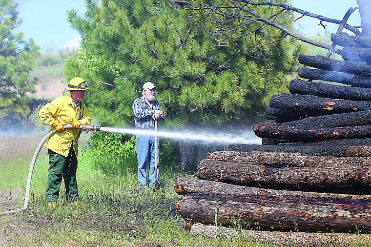 &lt;p&gt;Plains-Paradise Rural Firefighter Kevin Kerr works to put out the flames as Plains Trap Club groundskeeper Harry Greene watches.&#160;&lt;/p&gt;