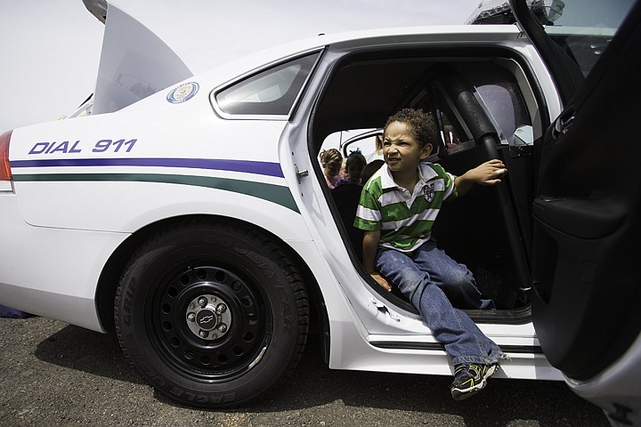 &lt;p&gt;SHAWN GUST/Press Kyjuan Mayer, a kindergarten student at Frederick Post Kindergarten, steps out of a Post Falls Police Department cruiser Wednesday as hundreds of students checked out police and fire department vehicles as part of Hero Day. The event was in conjunction with the school district's K-5 Food Drive Challenge and was an incentive for the children to make donations of food items.&lt;/p&gt;