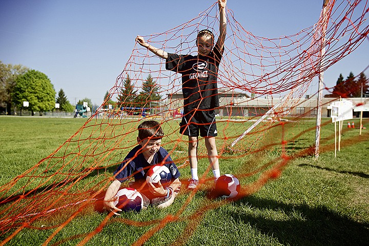 &lt;p&gt;JEROME A. POLLOS/Press Jacob Cook, 11, retrieve soccer balls with the help of Kiley Cutler, 10, following a celebration Friday for new soccer goals and soccer balls that were donated to the school. Skyhawk Sports donated 25 soccer balls to the school and the school's PTA helped fund the new soccer goals and nets.&lt;/p&gt;