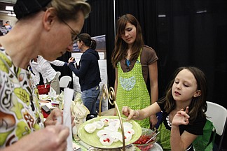 &lt;p&gt;Lexie Gauthier, 7 years old, right, shows Elizabeth Jantz, left, of Saint Ignatius her favorite gluten free snack at the Women 4 Wellness event, May 17, at Salish Kootenai College. Gauthier and her sister, Cassie Carlyle, 12 years old, center, help there mom hand out samples and sell recipe books.&lt;/p&gt;