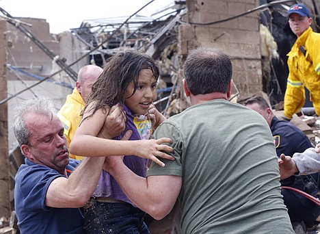 &lt;p&gt;A child is pulled from the rubble of the Plaza Towers Elementary School in Moore, Okla., and passed along to rescuers Monday. A tornado as much as a mile wide with winds up to 200 mph roared through the Oklahoma City suburbs Monday, flattening entire neighborhoods, setting buildings on fire and landing a direct blow on an elementary school.&lt;/p&gt;