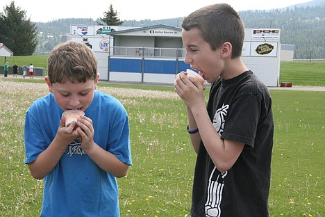 &lt;p&gt;Nine-year-old Jadyn Freeman, left, and 11-year-old Brandon Pastras lick ice cream cups at the Greyhound Park and Event Center in Post Falls on Saturday.&lt;/p&gt;