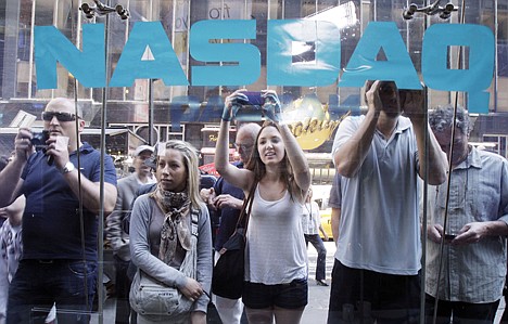 &lt;p&gt;FILE - In a Friday, May 18, 2012 file photo, curious bystanders watch through the Nasdaq windows as Facebook shares begin trading, in New York. Facebook's stock is sinking nearly 7 percent, Monday, May 21, 2012, falling below the $38 IPO price, in the social network's second day of trading as a public company. (AP Photo/Richard Drew, File)&lt;/p&gt;