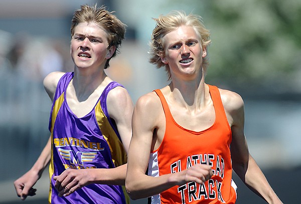 Missoula Sentinel's Jake Turner, left, and Flathead's Zach Perrin battle it out at the end of the boys 1600 at Western AA Divisional Track on Saturday in Kalispell. Turner pulled ahead to win with a time of 4:17.53 to Perrin's 4:17.54.