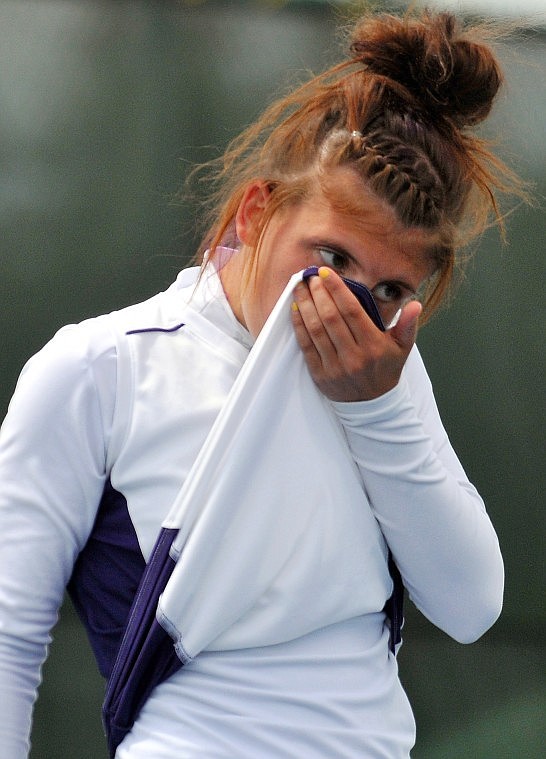 Polson's Jane Probst wipes her face with her shirt between sets in the Western A divisional singles championship match on Friday. Probst lost in the finals for a second-straight year to Mee.