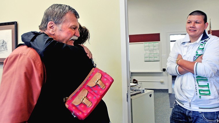 Kevin Calnan, director of Laser School, gets a hug from Carmina Lopez as her son Alfonso Lopez looks on following a meeting discussing Alfonso&#146;s remaining academic credits. Calnan, the director at the alternative school for 12 years, is retiring at the end of the school year.