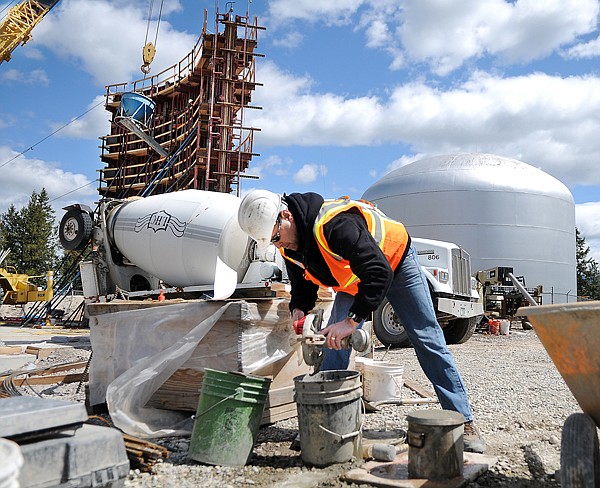 Kevin Malloy of Kalispell, with Carver Engineering, performs a test to make sure that there is sufficient oxygen in the concrete mix on Friday at the site of the new Evergreen water tank on Mission Trail Road in Kalispell. The first of six walls is up, according to Project Superintendent Kermit Johnsrud of DYK Incorporated they hope to have the tank completed in September.