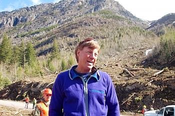 Avalanche technician Mark Dundas stands in front of a sprawling avalanche debris field along Going-to-the-Sun Road. Dundas said it is the largest he has ever encountered. The debris behind him rises 15 to 20 feet above the road. Jim Mann/Daily Inter Lake