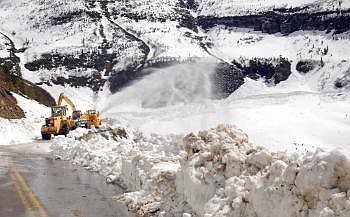 A rotary plow throws snow Thursday off Going-to-the-Sun Road in the Big Bend area about 3 miles from Logan Pass. A forecast for warm, sunny weather over the next few days should help park plow crews in their advance toward the pass. Jim Mann/Daily Inter Lake