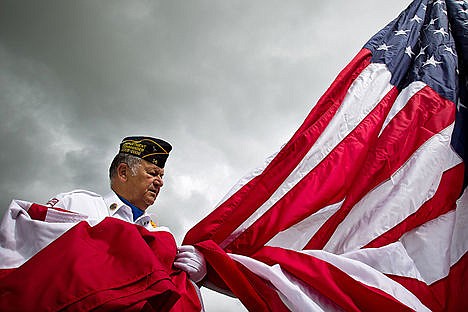 &lt;p&gt;In this May 28, 2010 Press file photo, David Sheridan, with the Kootenai County Veterans Council, holds the end of a 12-foot by 18-foot American flag prior to it being raised during a ceremony at Global Credit Union in Coeur d'Alene. Flag etiquette allows displaying the flag at half-mast for half the day on Memorial Day.&lt;/p&gt;