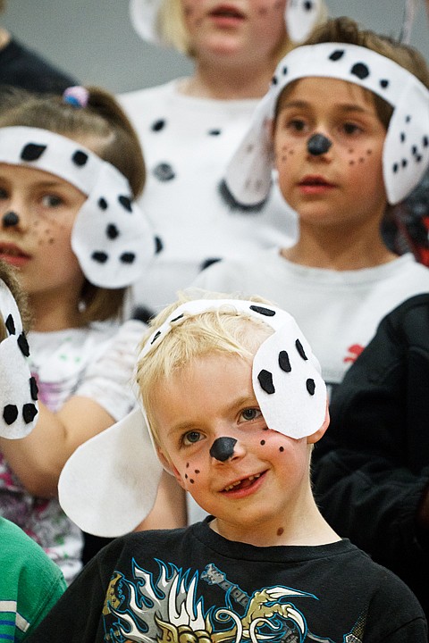 &lt;p&gt;SHAWN GUST/Press Gabe Kenyon, a first-grader at Skyway Elementary sings along with class mates Thursday during the school's end-of-year concert celebrating its Reading with Lucky program where students use stuffed puppies and accessories to promote reading.&lt;/p&gt;