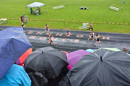 &lt;p&gt;Emily Gunlikson leads her heat of the 200 sprint in a driving rain Saturday at the Western A track meet in Frenchtown.&lt;/p&gt;