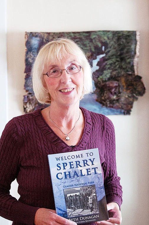 <p>Beth Dunagan poses with her memoir about growing up at the Sperry Chalet. May 5, 2014 in Whitefish, Montana. (Patrick Cote/Daily Inter Lake)</p>