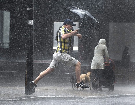 &lt;p&gt;A man leaps over a puddle during a heavy rain shower in Montreal, Thursday.&lt;/p&gt;