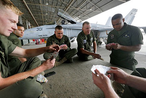 &lt;p&gt;U.S. Marines play spades during a break at the 309th Aerospace Maintenance and Regeneration Group boneyard in Tucson, Ariz. The Marines are repairing F-A-18's to return to service at the 309th facility.&#160;&lt;/p&gt;