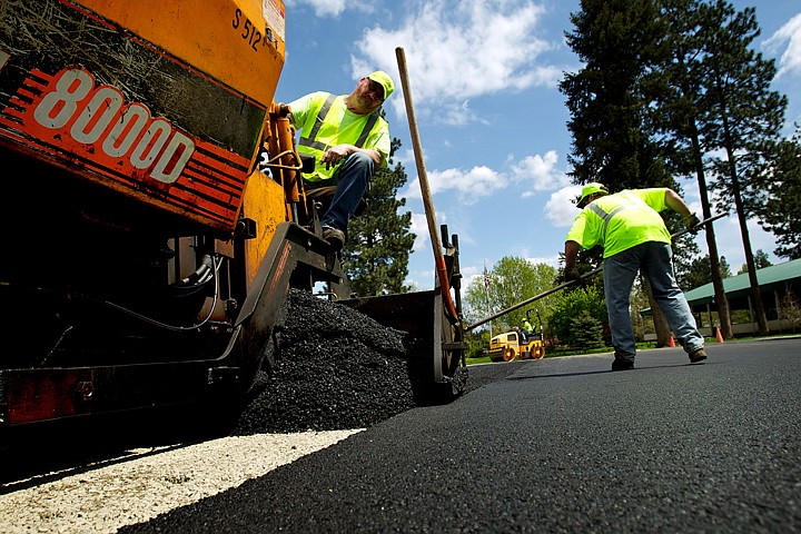 &lt;p&gt;Kevin Desilets keeps an eye on the distribution of fresh asphalt Monday as a street maintenance crew from the city of Post Falls resurfaces the parking area at Q'emiln Park.&lt;/p&gt;