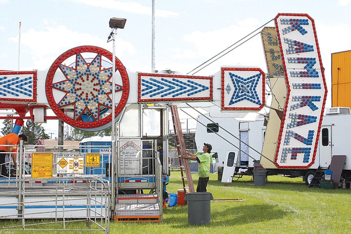 Haworth Family Shows workers set up a carnival behind Frontier Middle School Tuesday evening. The carnival kicks off Thursday at 4 p.m. and runs through Sunday as part of the Moses Lake Spring Festival.