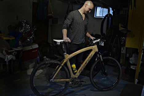 &lt;p&gt;Stephen Ziegenfuss stands in his basement and woodworking space with a wooden bicycle that he built, in Jackson, Mich., April 16.&lt;/p&gt;