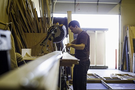 &lt;p&gt;Jett Bingman, set builder, cuts lumber to length while working on a stage prop during his shift.&lt;/p&gt;