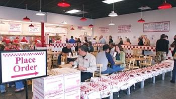 Customers line up at Five Guys Burgers and Fries during the lunch rush Tuesday afternoon. Since the restaurant opened on April 20, it has exceeded expectations for revenue. The restaurant employs 41 workers and three managers. Allison Money/Daily Inter Lake