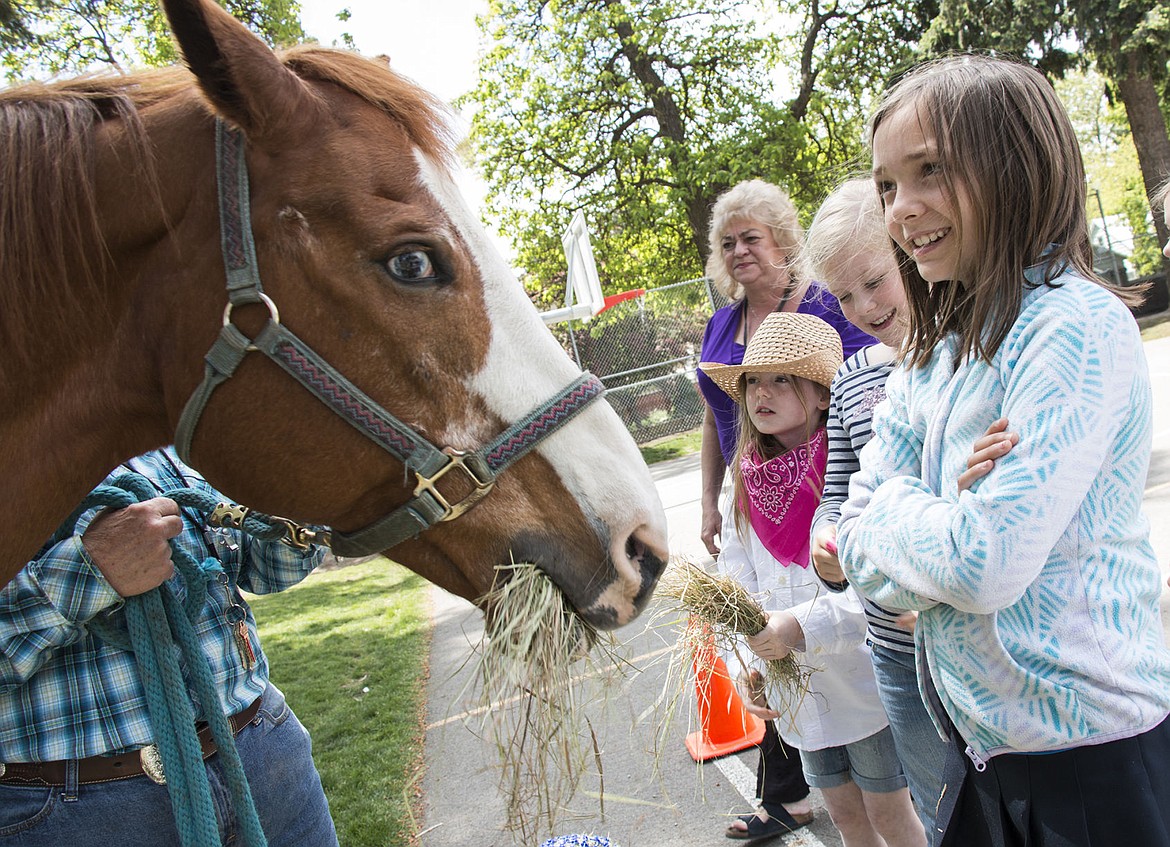 &lt;p&gt;From left to right, Naveah Laskey, Addelin Memmer, and Ashton Clancy, feed Betty the horse at Sorensen Elementary School Friday, May 20.&lt;/p&gt;