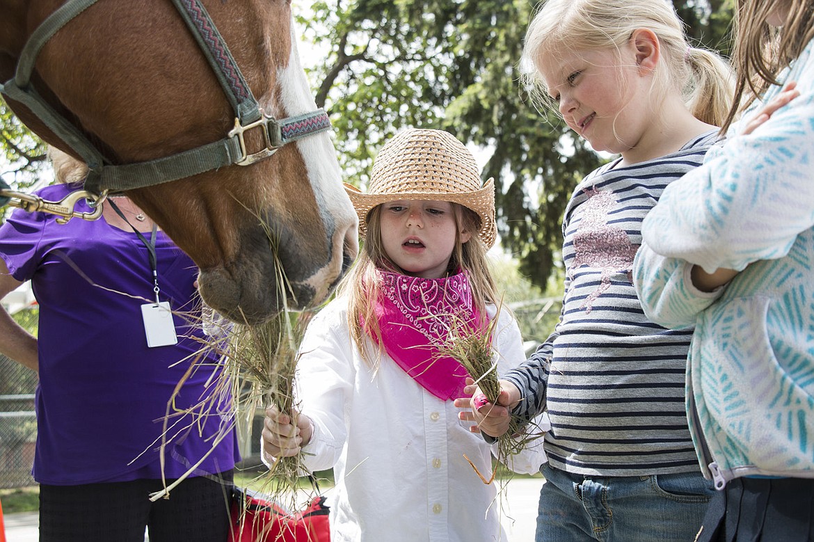 &lt;p&gt;Naveah Laskey, left, and Addelin Memmer, right, feed Betty the horse at Sorensen Elementary School.&lt;/p&gt;