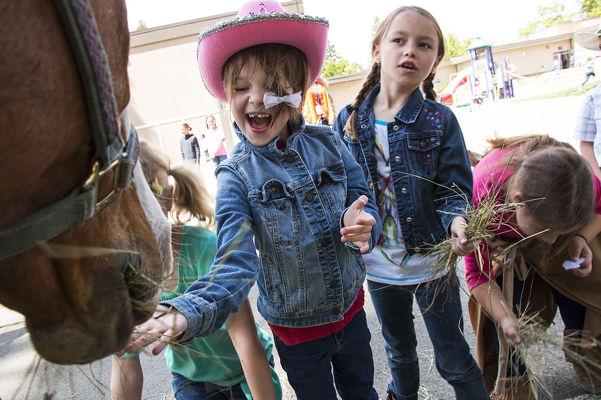 &lt;p&gt;Violet Petersen, left, and Layla Gibb, right, feed Betty the horse at Sorensen Elementary School. Janet Ackerman, Principal at Sorensen is retiring after this school year and celebrated by bringing her horses to school for the kids to pet.&lt;/p&gt;