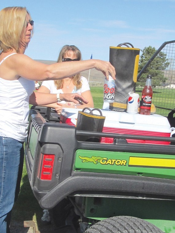 Traveling refreshment cart operators Janet Eckenberg, left, and Stacey Robinson set up shop at one of the holes to serve the thirsty field of 74 players. They also enjoyed a chicken lunch.