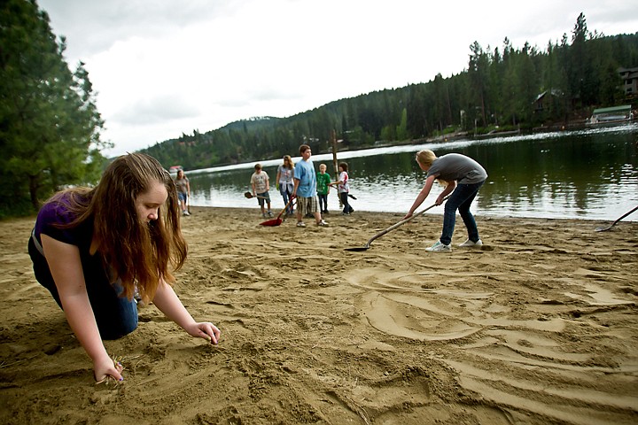 &lt;p&gt;JEROME A. POLLOS/Press Cassidy Huckaby, 11, clears weeds out of the freshly spread sand on the beach Tuesday at Kiwanis Park in Post Falls. Huckaby, a fifth-grade student from Ponderosa Elementary, was part of a team of more than 100 students from the school who took part in the &quot;Take Pride in America&quot; program that encourages and recognizes efforts that promote taking pride by taking care of public lands.&lt;/p&gt;