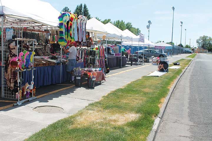 Vendors set up before the start of the Moses Lake Spring Festival Thursday. About 45 commercial vendors will be at this year's event.