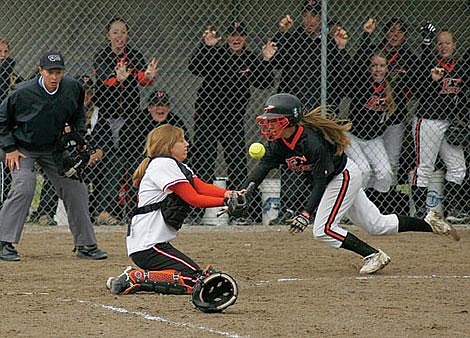 Flathead shortstop Courtney Sverdrup runs home while Billings Senior catcher Casey Kennedy waits for the ball during Thursday&#146;s game at the State Class AA Softball Tournament in Kalispell. Sverdrup scored on the play and Flathead won 5-1.Kristine Paulsen/Daily Inter Lake