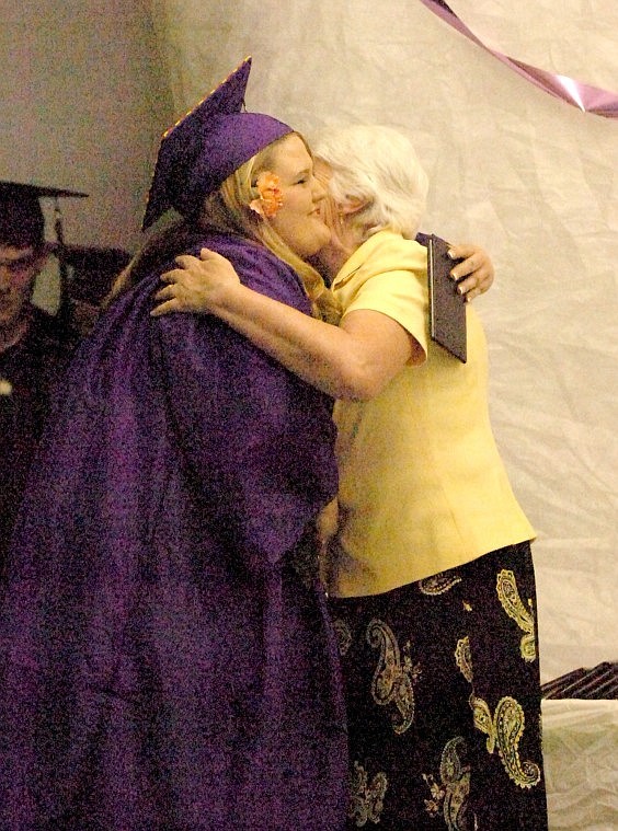 Jessica Anderson gets a hug after receiving her diploma.