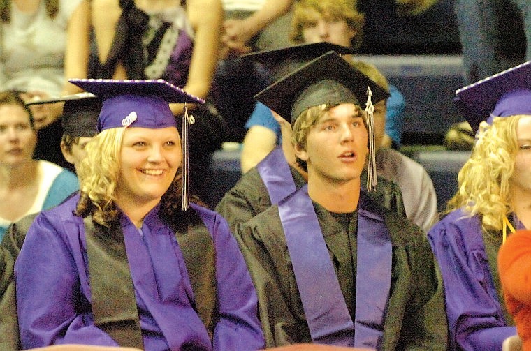 Moriah Gilmore and Kaileb Gillingham watch their fellow classmates graduate.