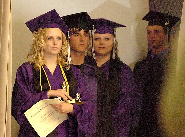 Kristi Fulleron, Kaileb Gillingham and Moriah Gilmore wait to walk across the stage and take their diploma.