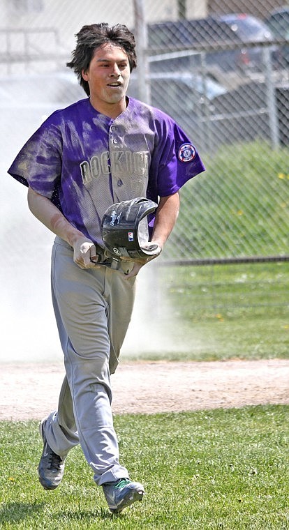 Dakota Matt walks back to the dugout after sliding into home plate.