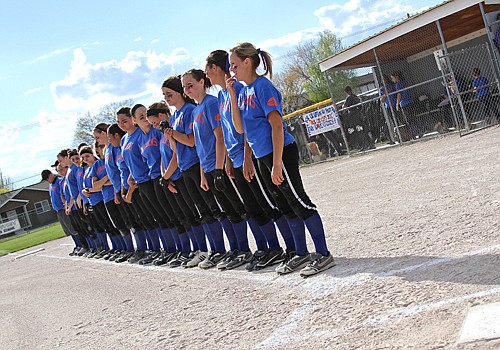 The Ronan Maidens softball team wears royal blue uniforms to show their support for head coach, Tom Peterson, who was recently diagnosed with cancer.