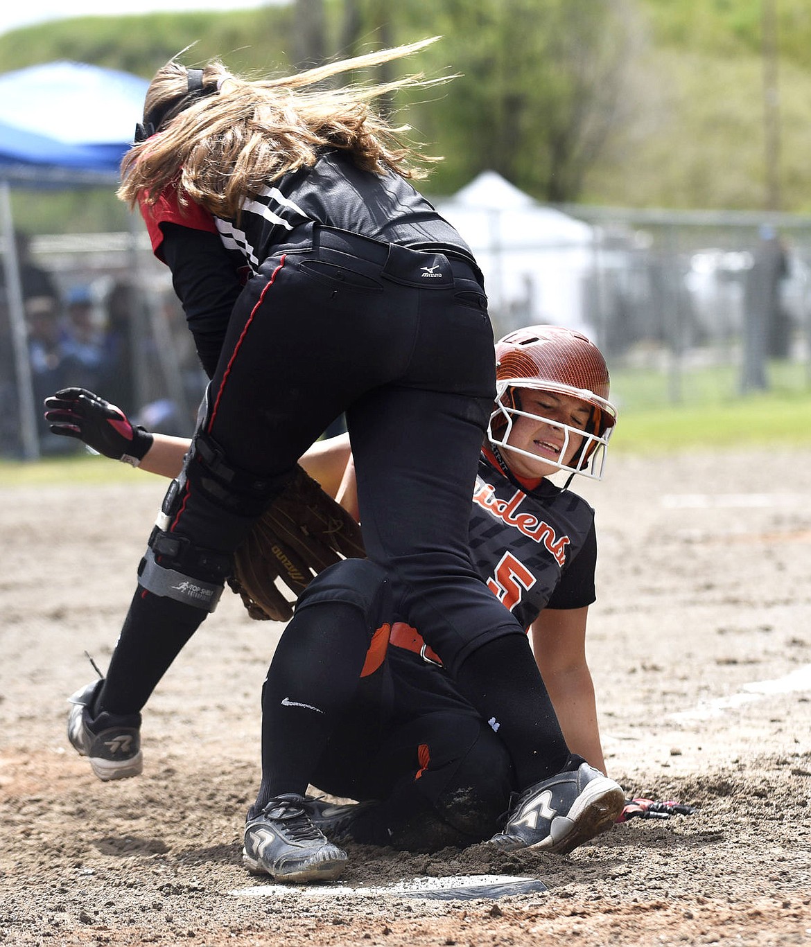 &lt;p&gt;Ronan's Carston Rhine safely slides home as Huntley Project pitcher Tessa Hultgren attempts to tag her as Rhine steals home during the opening round of the Montana B/C Softball tournament in Kalispell on Thursday, May 26, 2016. (Aaric Bryan/ Daily Inter Lake)&lt;/p&gt;