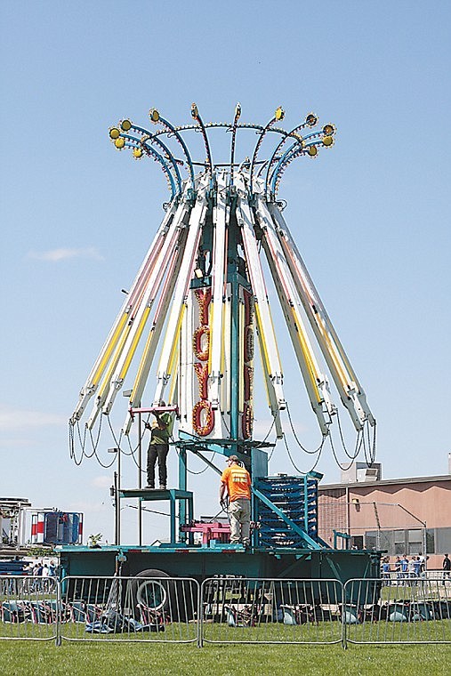 Workers were making progress on assembling rides for the upcoming Moses Lake Spring Festival Tuesday near McCosh Park. The event starts Thursday and ends Sunday.