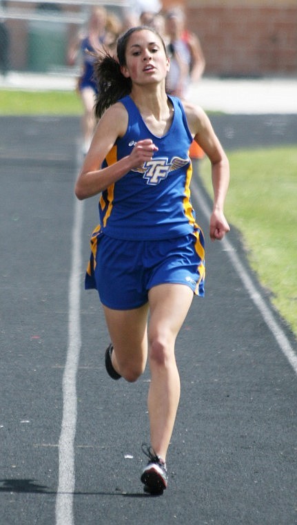 Beca Gunderson runs down the track in the mile race coming in third place.