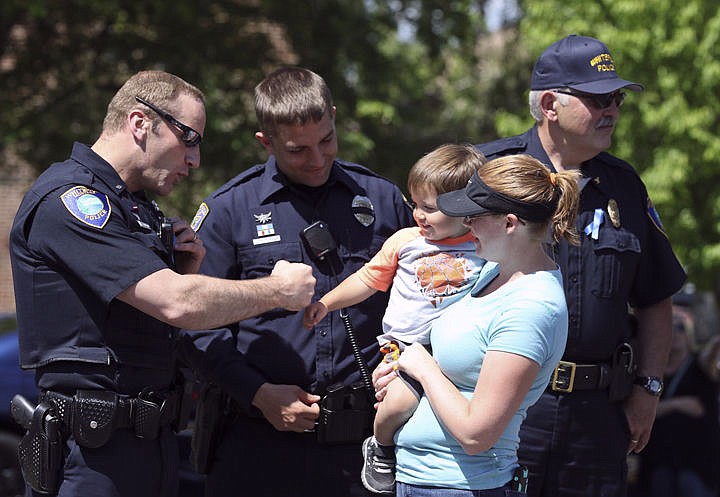 &lt;p&gt;Abel Adams of Ronan, held by his mom, Chelsea, fist bumps a few law enforcement officers before the memorial last Wednesday in Polson. His dad is a tribal law enforcement officer.&lt;/p&gt;