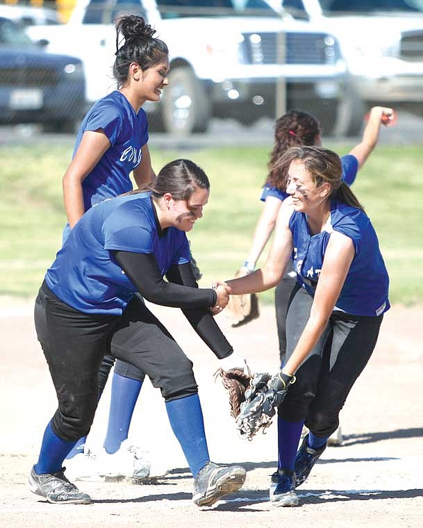 Leilani Pruneda (left) and Allycia Gonzales (right) celebrate an out during the first round of the district tournament.