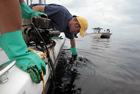 &lt;p&gt;Kevin Boswell, a researcher from LSU, trailed a gloved hand through oil floating on the surface of the Gulf of Mexico near the coast of Louisiana, Wednesday.&lt;/p&gt;