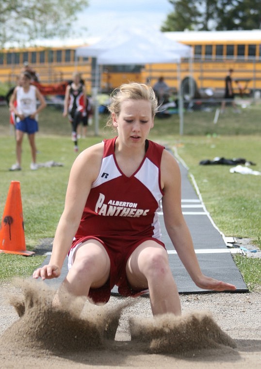Andi Clark jumps 13 feet in the long jump.