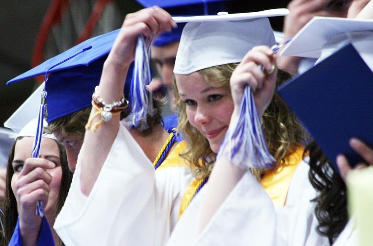 Velita Brown, middle, shifts her tassle to the right side resembling the fact that the students have now graduated from the high school.